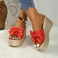 Red bow wedge sandals featuring gold grid pattern and stylish metallic platform sole. - 35 / Red