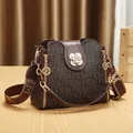 Vintage brown monogram bucket bag with stylish wide strap and floral clasp - Style F / Coffee