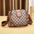 Stylish monogram bucket bag with gold-tone floral hardware and adjustable strap. - Checkered / Brown