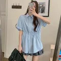 Stylish women's light blue short-sleeved shirt with a flattering shirred waist design. - Blue