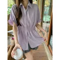Elegant purple short-sleeved shirt with a cinched waist design for a slimming effect. - Purple