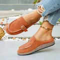Stylish brown faux suede platform mules with metal buckle detail shown in outdoor light. - 36 / Orange Red