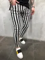 Close-up detail of men's black and white vertical striped skinny fitness running pants - M / Bottoms / Note