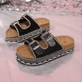 Detailed view of black platform sandals featuring double buckle straps and rhinestone borders - 36 / Black