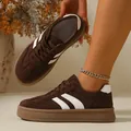 Close-up detail view of women's retro brown suede GAT sneakers with white stripe accents - 36 / Brown