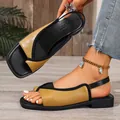 Detail view of stylish yellow and black square toe sandals worn on foot - Yellow
