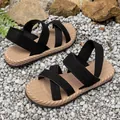 Close-up of lightweight flat Roman sandals with black cross straps and rope-textured soles - 36 / Black