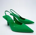 Detail view of vibrant green pointed-toe slingback heels with elegant stiletto heels. - 35 / Green
