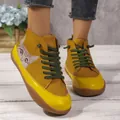 Detail of women's color-block high-top flat shoes with cute cat graphic and green laces - 36 / Yellow