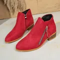 Detailed view of red suede women's ankle boots featuring chunky heels and double side zippers - Red