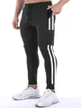 Detailed view showing side stripes and functional pocket of men's athletic joggers. - S / Bottoms / Black