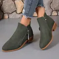 Detailed macro shot of dark green suede ankle boots featuring trendy side zipper accents - Army Green