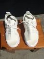 Detailed top-down view of white fly-knit platform sports sandals on a wooden surface - 35 / White
