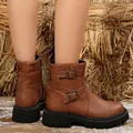 Detail of brown vintage Martin boots with buckle straps and a thick black lug sole. - 38 / Double Buckle Yellow Brown