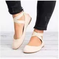 Close-up detail of beige retro flat shoes featuring elastic cross ankle straps on a model - 35 / Beige