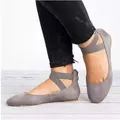 Close-up of grey vintage flat shoes with crossover elastic straps worn with black jeans - 35 / Gray