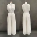 Detailed front and back view of a stylish white sleeveless pleated wide-leg jumpsuit with zipper - XS / Milky White