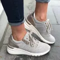 Detailed close-up of grey platform sneakers with side zipper and metallic heel accents. - 37 / Gray