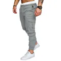 Close-up detail of grey men's multi-pocket cargo pants showing pocket design and fit - M / Bottoms / Gray