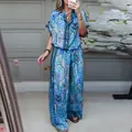 Detail view of blue floral printed two-piece set with short sleeve top and wide trousers - XS / Top And Bottom / Lake Blue