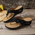 Black wedge thong sandals with elegant floral accents and sparkling rhinestone details. - 36 / Black