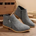 Detailed side view of grey women's pointy toe ankle boots with chunky heel and side zipper. - 36 / Gray