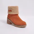 Detailed view of women's orange suede snow boots with plush faux shearling cuff. - 35 / Orange