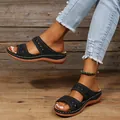 Detail view of women's vintage black wedge sandals with decorative stitching on wood floor - 36 / Black