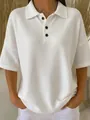 Close-up detail of white waffle knit short sleeve polo shirt featuring button collar. - S / Tops / White