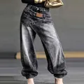 Close-up detail of deconstructed wrap-waist jeans in distressed grey denim for women - 3XL / Bottoms / Black