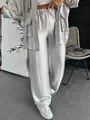 Detailed view of shiny silver wide-leg trousers with drawstring elastic waist - Silver