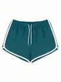 Dettaglio dei pantaloncini sportivi verde acqua da donna con bordo bianco e coulisse - Verde malachite