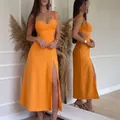 Detail view of an elegant orange sleeveless maxi dress with a stylish thigh-high slit - XS / Dresses / Orange Red