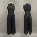 Detailed front and back view of an elegant black pleated sleeveless wide-leg jumpsuit for women - XS / Black