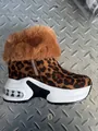 Detail of leopard print snow boot with plush faux fur collar and white platform sole - Leopard Print