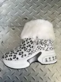 Detailed side view of leopard print snow boots with white fur collar and platform sole - 36 / White