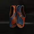 Close-up detail of stylish color-blocked leather flat sandals with adjustable buckle strap - Brown Blue