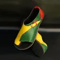 Detail view of vibrant color-block flat leather sandals with stylish metal buckle. - Yellow-Green