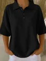 Close-up detail of a women's black waffle knit short sleeve Polo shirt with button collar - S / Tops / Black