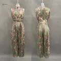 Detailed view showing the front and back of a green floral pleated wide-leg jumpsuit - XS / Green