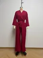 Detail showing the deep V-neck and balloon sleeve design of this red wide-leg jumpsuit - S / Set / Burgundy