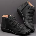 Black women's flat ankle boots with side zipper and criss-cross strap design - Black
