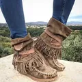 Detail shot of brown suede fringe boots with decorative straps and bohemian stitching - Army Green