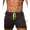 Close-up detail of men's black athletic shorts featuring a vibrant neon yellow drawstring - M / Bottoms / Black