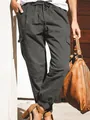 Detailed view of dark grey women's cargo pants with drawstring waist and large side pockets - S / Bottoms / Gray