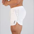 Close-up of men's white quick-dry athletic shorts with drawstring and side logo - M / Bottoms / White