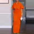Detail view of vibrant orange two-piece set featuring cropped shirt and maxi skirt - XS / Top And Bottom / Orange