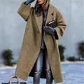 Detail view of a woman wearing an oversized camel wool coat in an urban street setting - S / Top (155) / Khaki