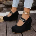 Macro detail of black suede platform wedge shoes featuring double buckle straps - 38 / Black