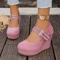 Detail view of pink suede wedge shoes with adjustable double straps and metal buckles. - 36 / Pink